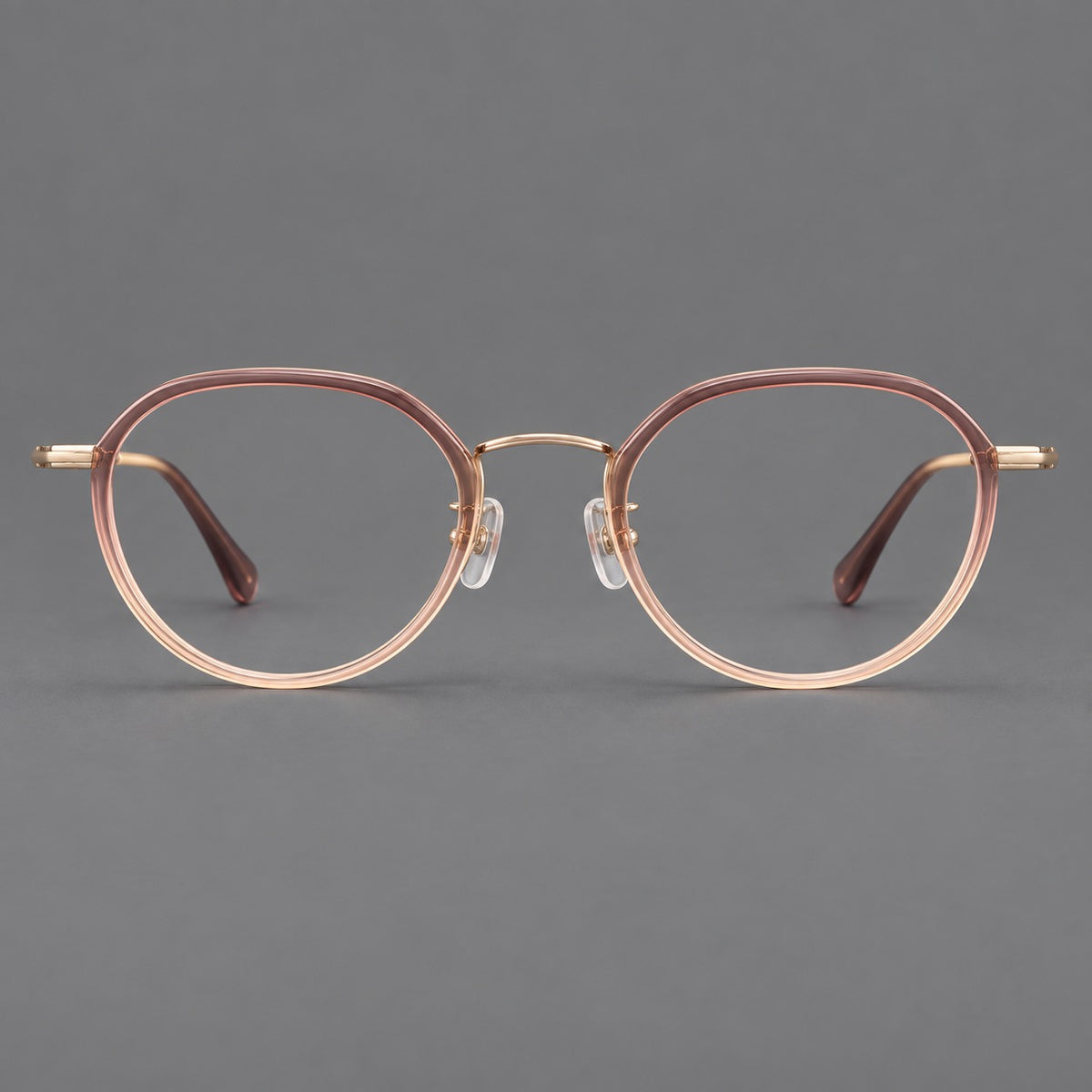 Rounded eyeglasses in acetate and titanium with gently arched brows and engraved metal temples in Pink Tea Gradient / Rose Gold, front view
