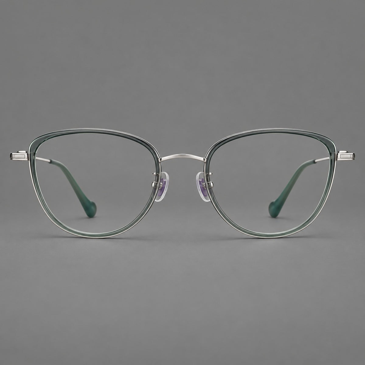 Upswept eyeglasses in acetate and titanium with softly rounded rims and tapered metal temples in Clear Green / Silver, front view