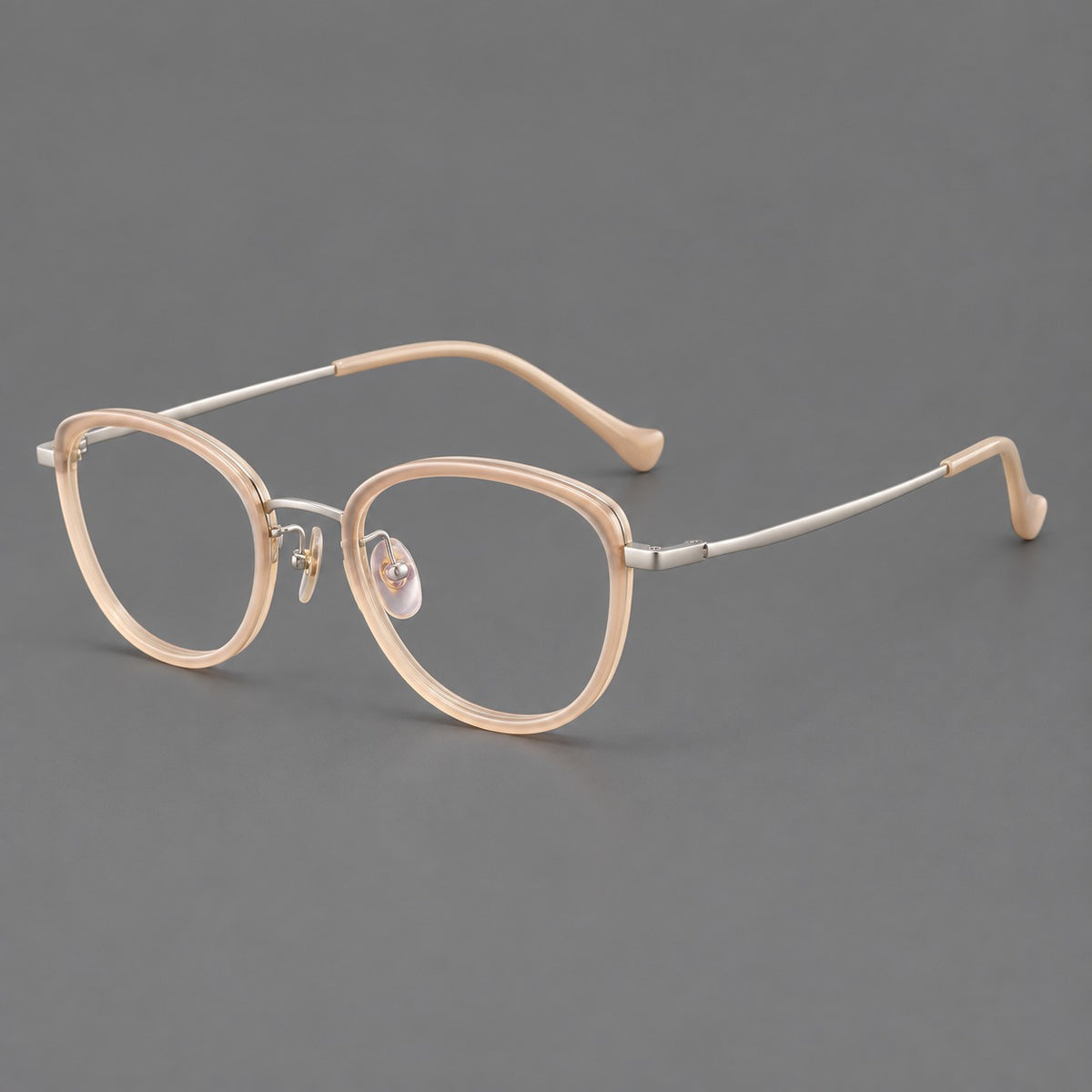 Upswept eyeglasses in acetate and titanium with softly rounded rims and tapered metal temples in Nude Pink / Silver, three quarter view