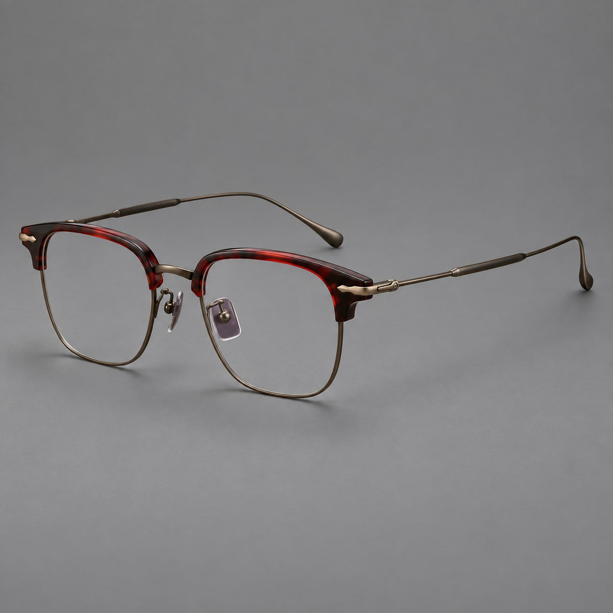 Browline eyeglasses in acetate and titanium with slim metal lower rims and decorative corners in Red Tortoiseshell / Antique Bronze, three quarter view