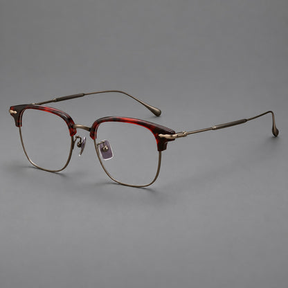 Browline eyeglasses in acetate and titanium with slim metal lower rims and decorative corners in Red Tortoiseshell / Antique Bronze, three quarter view lens detail