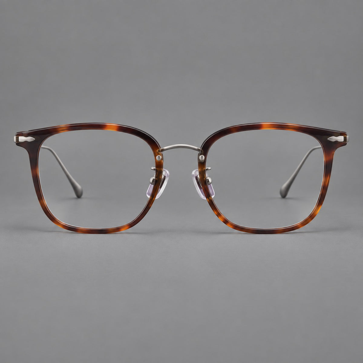 Retro square eyeglasses in acetate and titanium with rounded edges and sculpted corner accents in Tortoiseshell / Antique Copper, front view