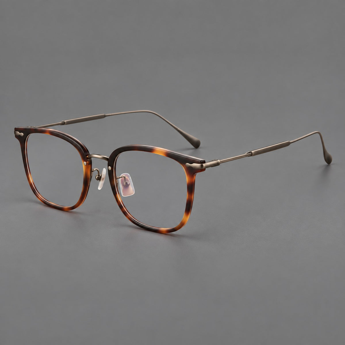 Retro square eyeglasses in acetate and titanium with rounded edges and sculpted corner accents in Tortoiseshell / Antique Copper, three quarter view