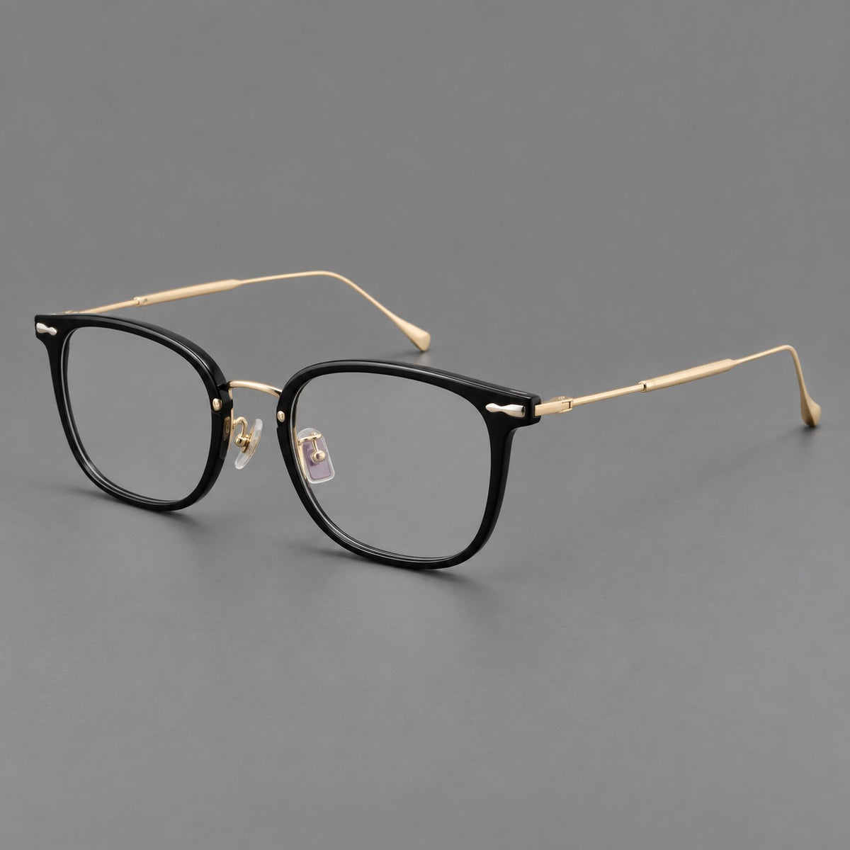 Retro square eyeglasses in acetate and titanium with rounded edges and sculpted corner accents in Glossy Black / Gold, three quarter view