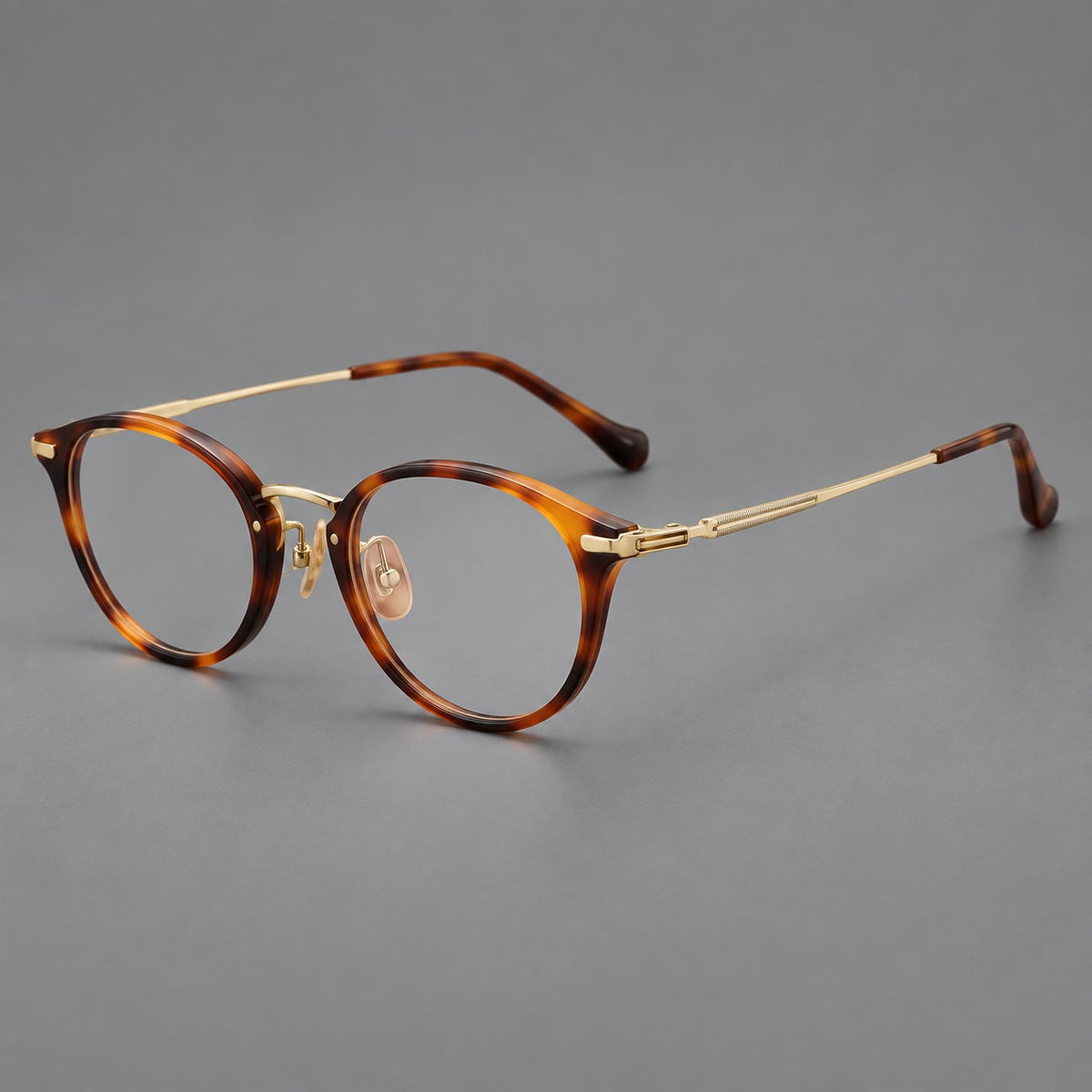 Vintage panto eyeglasses in acetate and titanium with raised brows and textured metal temples in Tortoiseshell / Gold, three quarter view