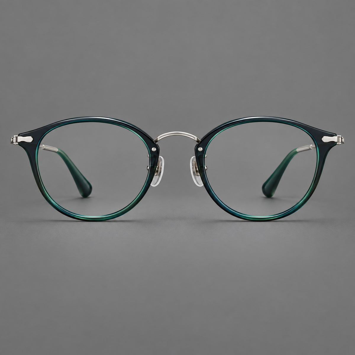 Vintage panto eyeglasses in acetate and titanium with raised brows and textured metal temples in Peacock Blue / Silver, front view