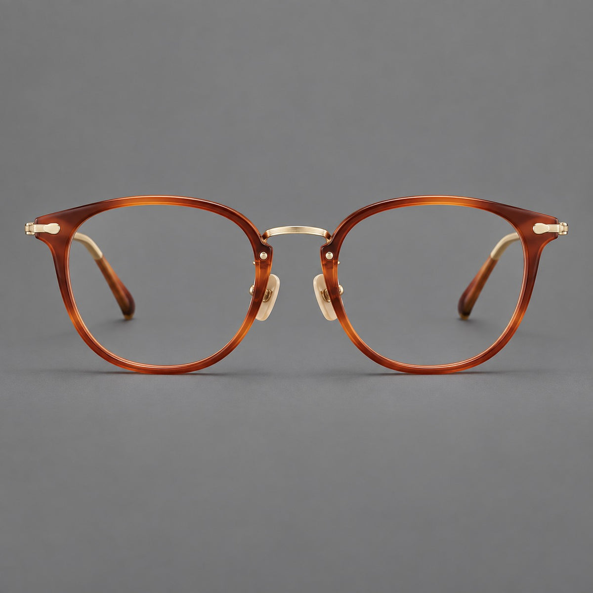 Classic soft square eyeglasses in acetate and titanium with engraved temples and corner accents in Amber Tortoiseshell / Gold, front view
