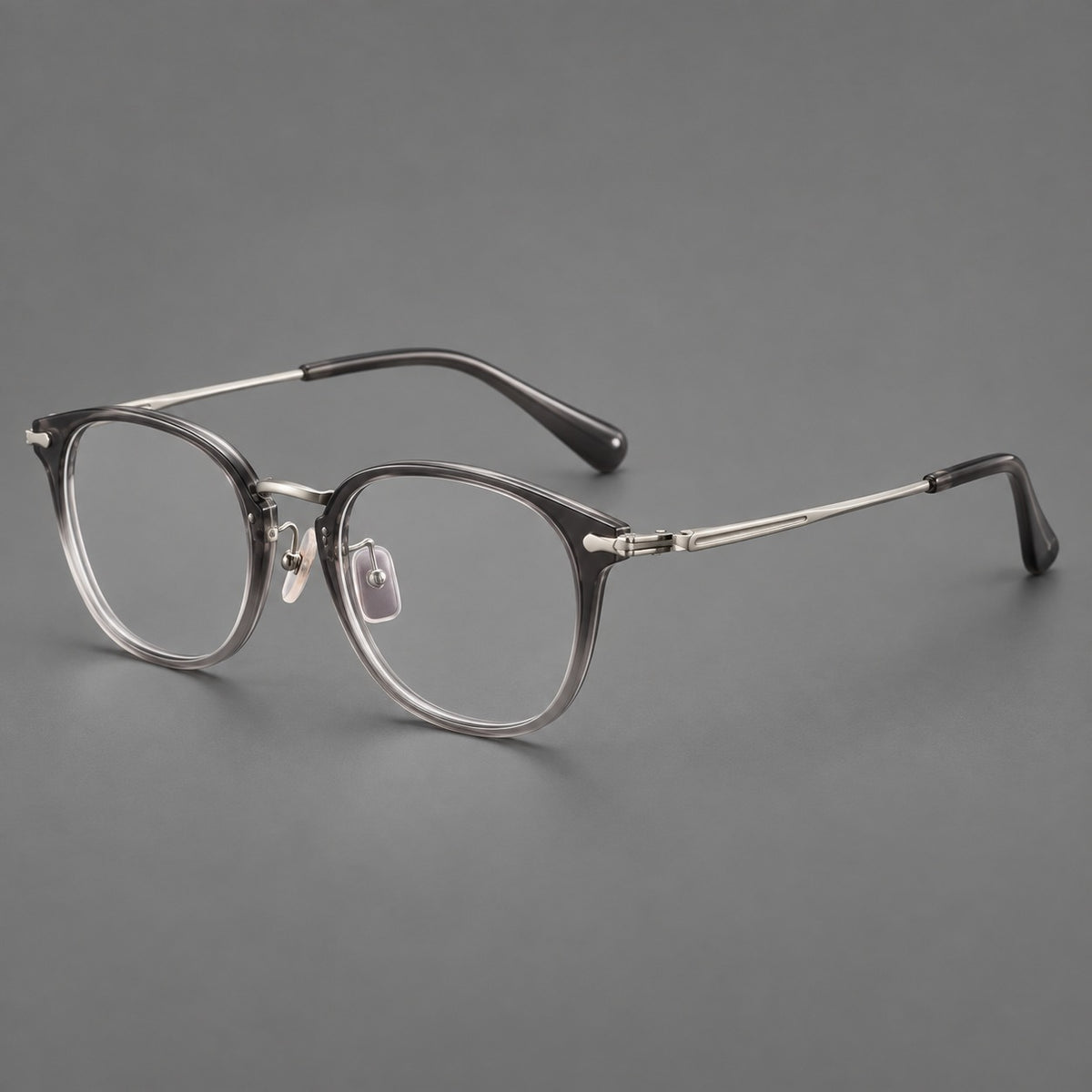 Classic soft square eyeglasses in acetate and titanium with engraved temples and corner accents in Mist Grey / Silver, three quarter view