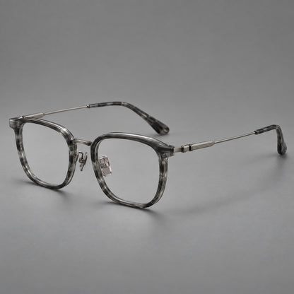 Soft square eyeglasses in acetate and titanium with wide upper corners and fine metal temples in Marbled Grey / Gunmetal, three quarter view front view