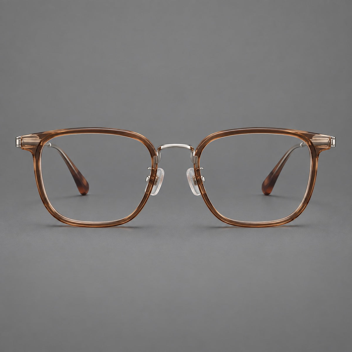 Soft square eyeglasses in acetate and titanium with wide upper corners and fine metal temples in Clear Tea / Silver, front view