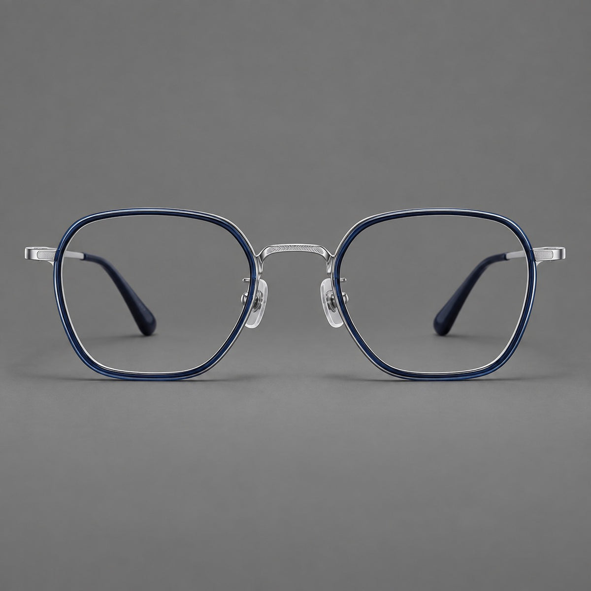 Soft square eyeglasses in acetate and titanium with slim rims and a finely engraved metal bridge in Blue / Silver, front view