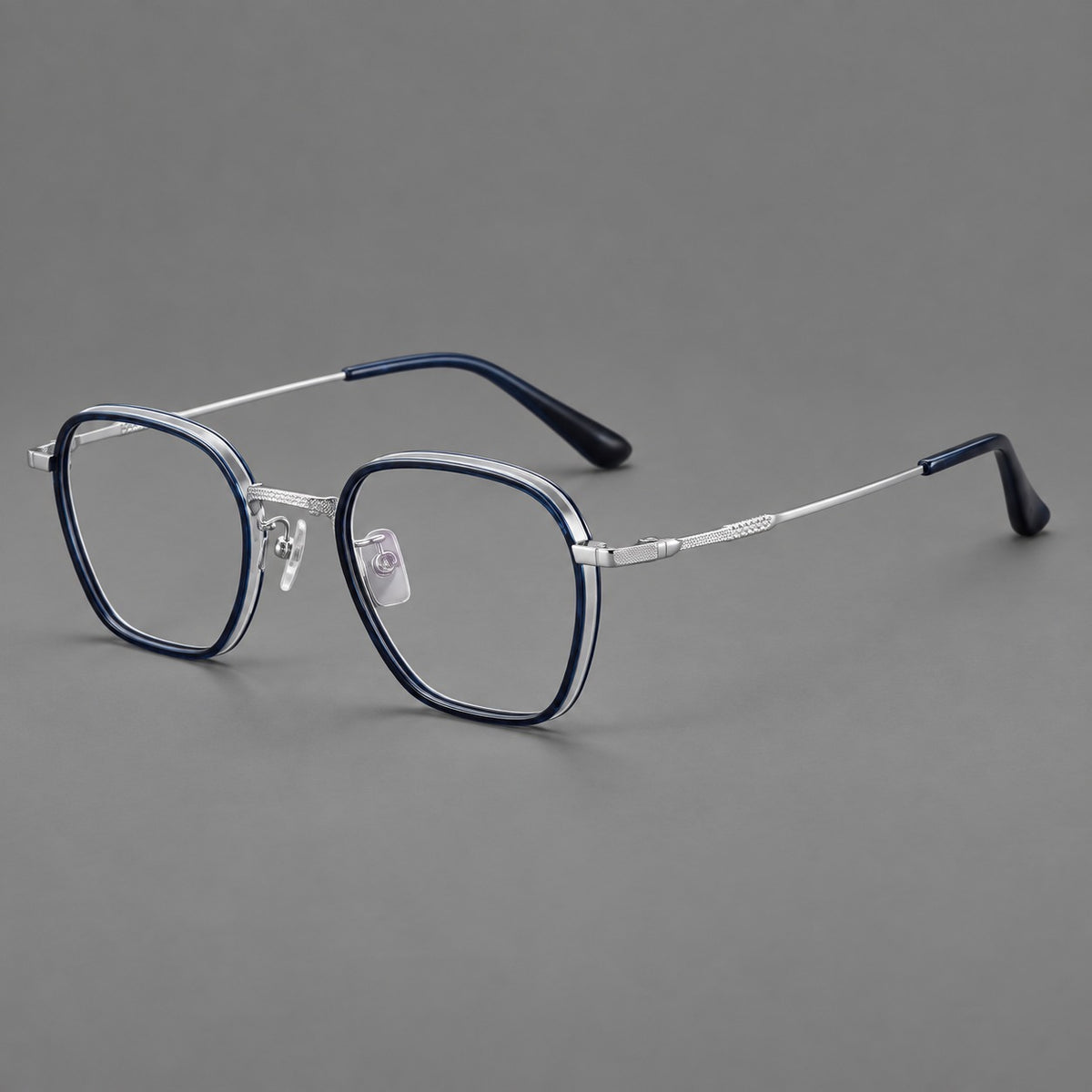 Soft square eyeglasses in acetate and titanium with slim rims and a finely engraved metal bridge in Blue / Silver, three quarter view