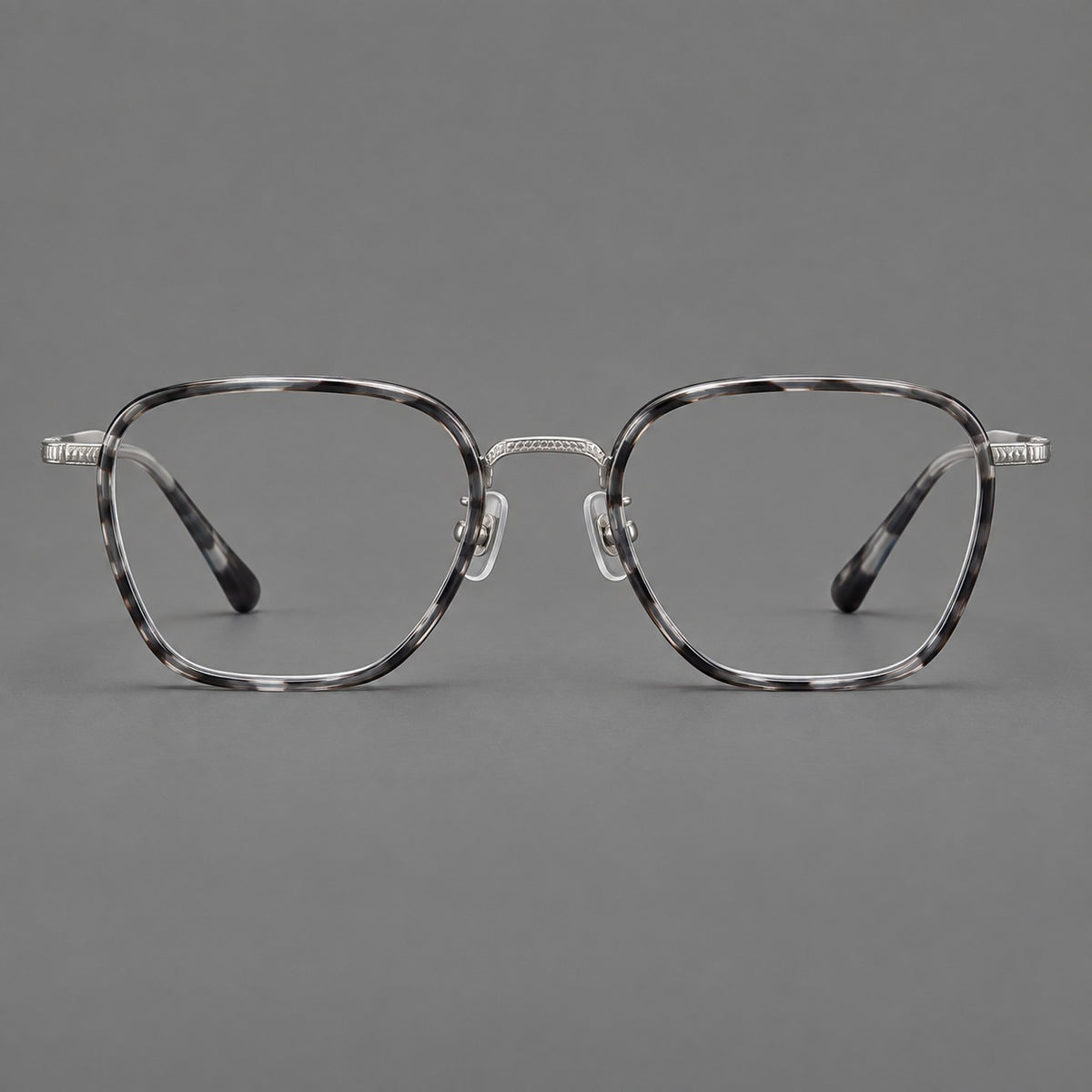 Soft square eyeglasses in acetate and titanium with slim rims and a finely engraved metal bridge in Grey Tortoiseshell / Silver, front view