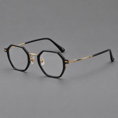 Geometric eyeglasses in acetate and titanium with octagonal rims and a textured metal bridge in Glossy Black / Antique Gold, three quarter view lens detail