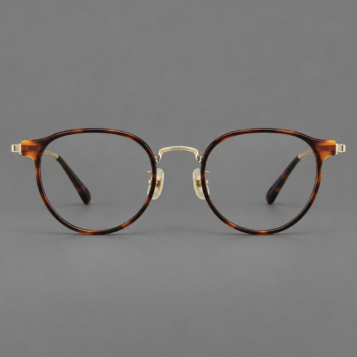 Round eyeglasses in acetate and titanium with widened outer corners and slender metal temples in Tortoiseshell / Gold, front view