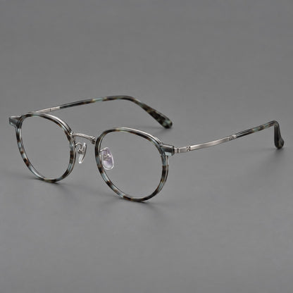 Round eyeglasses in acetate and titanium with widened outer corners and slender metal temples in Green Grey Tortoiseshell / Gunmetal, three quarter view front view