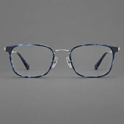 Rounded rectangular eyeglasses in acetate and titanium with bold corners and engraved metal temples in Blue / Gunmetal, front view frame detail