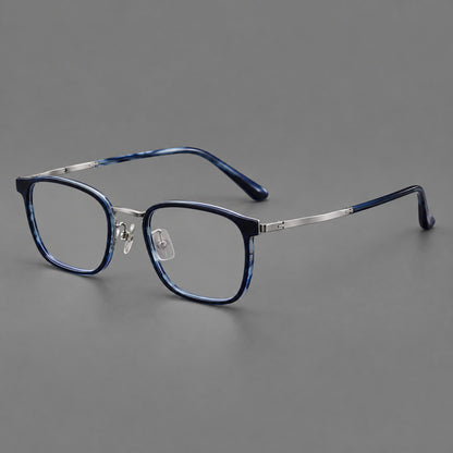 Rounded rectangular eyeglasses in acetate and titanium with bold corners and engraved metal temples in Blue / Gunmetal, three quarter view front view