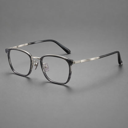 Rounded rectangular eyeglasses in acetate and titanium with bold corners and engraved metal temples in Clear Grey / Gunmetal, three quarter view additional product view