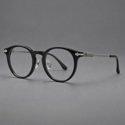 Retro acetate and titanium eyeglasses with round rims and a pronounced keyhole bridge in Black / Grey, three quarter view front view