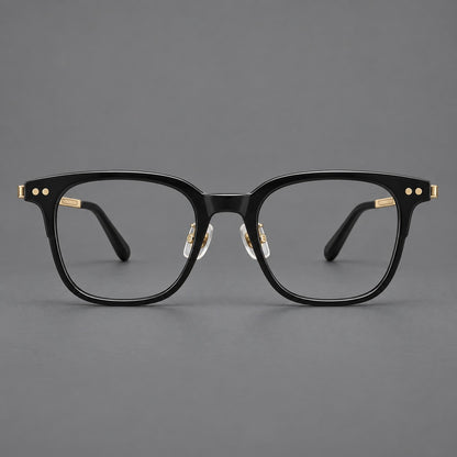 Classic acetate and titanium eyeglasses with squared brows and paired corner rivets in Black / Gold, front view temple detail