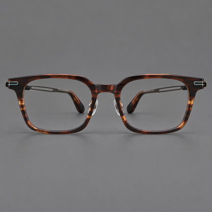 Modern acetate and titanium eyeglasses with angular square rims and curved metal hinges in Striped Brown / Antique Bronze, front view frame detail