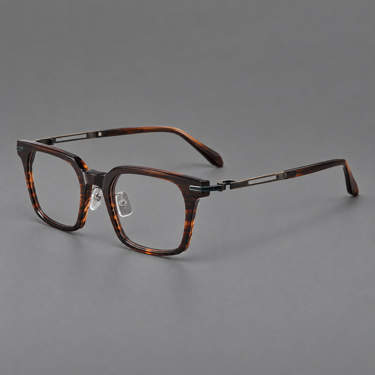 Modern acetate and titanium eyeglasses with angular square rims and curved metal hinges in Striped Brown / Antique Bronze, three quarter view