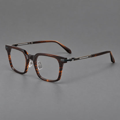 Modern acetate and titanium eyeglasses with angular square rims and curved metal hinges in Striped Brown / Antique Bronze, three quarter view front view