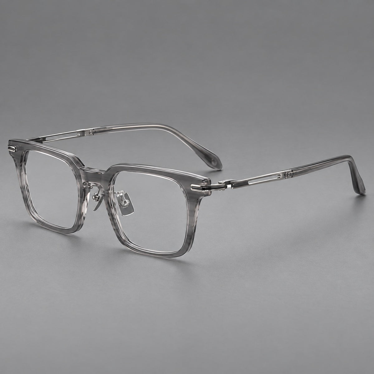 Modern acetate and titanium eyeglasses with angular square rims and curved metal hinges in Clear Grey, three quarter view