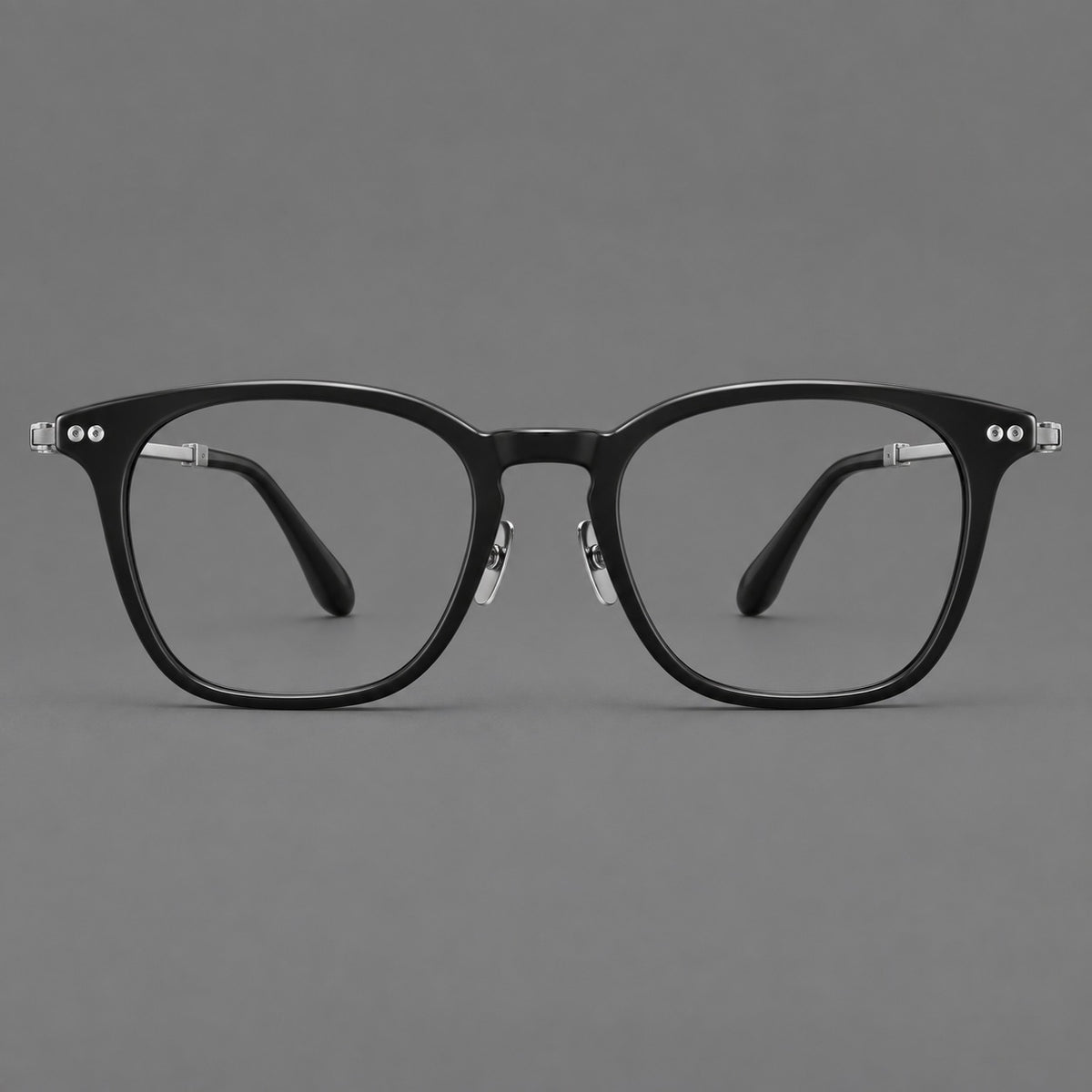 Retro acetate and titanium eyeglasses with gently squared rims and circular metal hinges in Black / Silver, front view