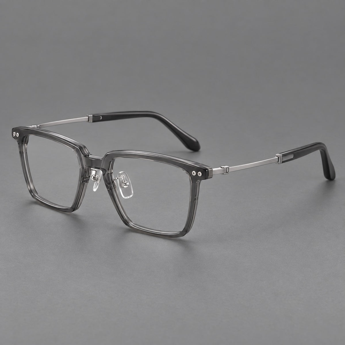 Classic acetate and titanium eyeglasses with a straight brow and rounded rectangular rims in Clear Grey / Silver, three quarter view