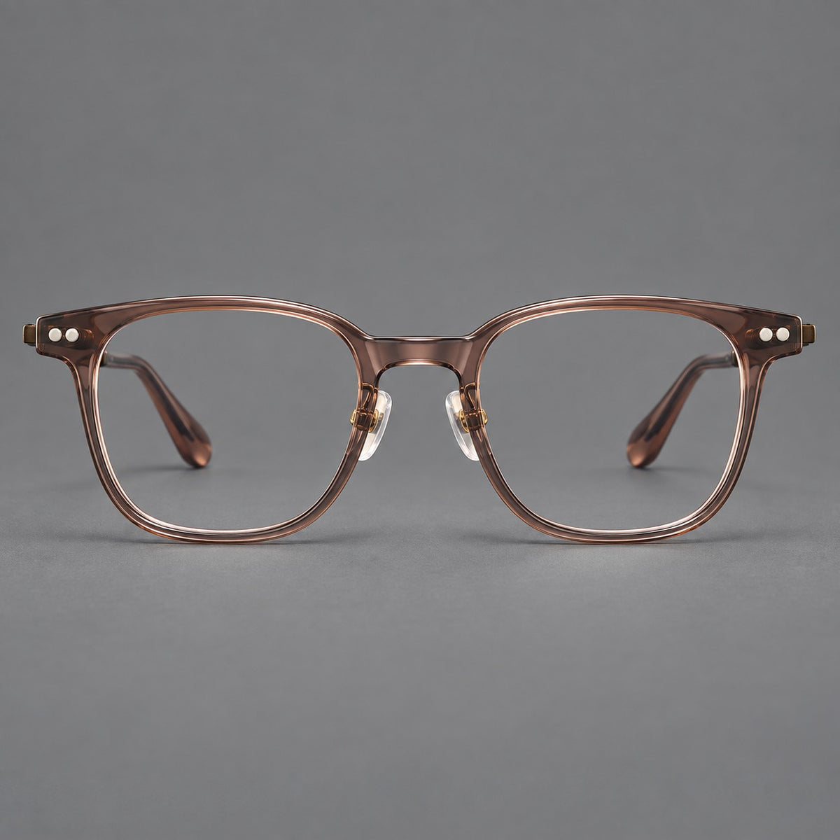 Vintage acetate and titanium eyeglasses with soft square rims and paired metal rivets in Clear Brown / Antique Bronze, front view