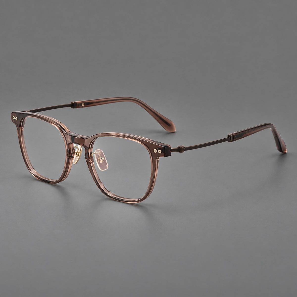 Vintage acetate and titanium eyeglasses with soft square rims and paired metal rivets in Clear Brown / Antique Bronze, three quarter view