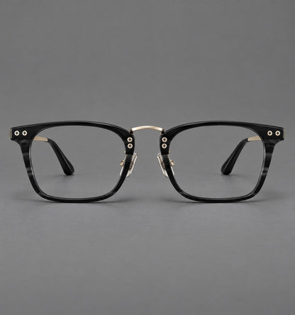 Acetate and titanium eyeglasses with angular rectangular rims and a curved metal bridge in Black / Gold, front view temple detail