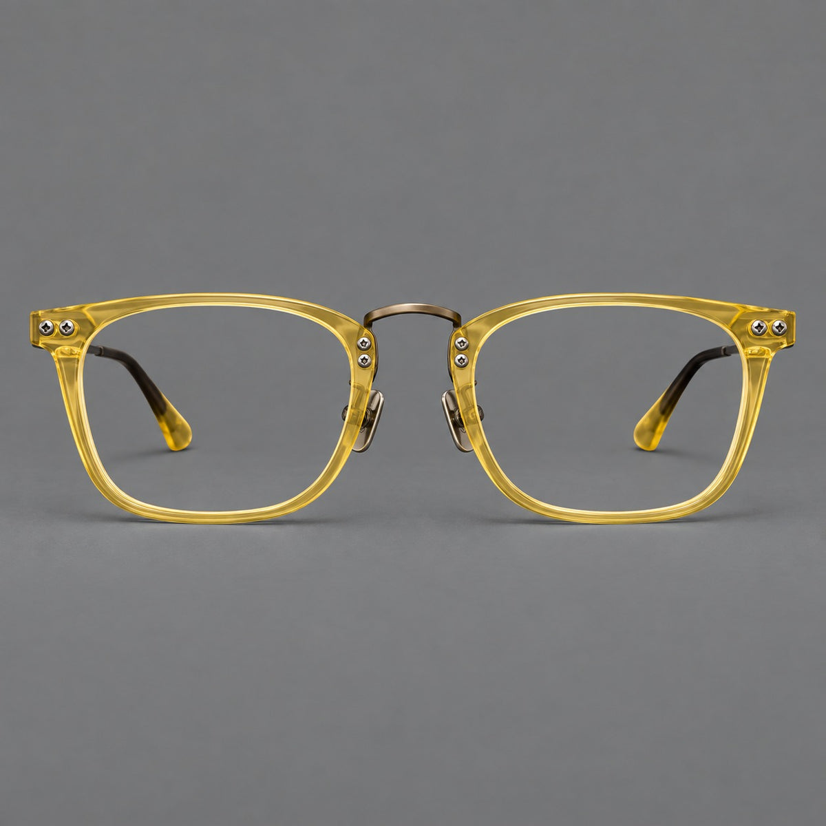 Acetate and titanium eyeglasses with angular rectangular rims and a curved metal bridge in Jade Yellow / Antique Bronze, front view