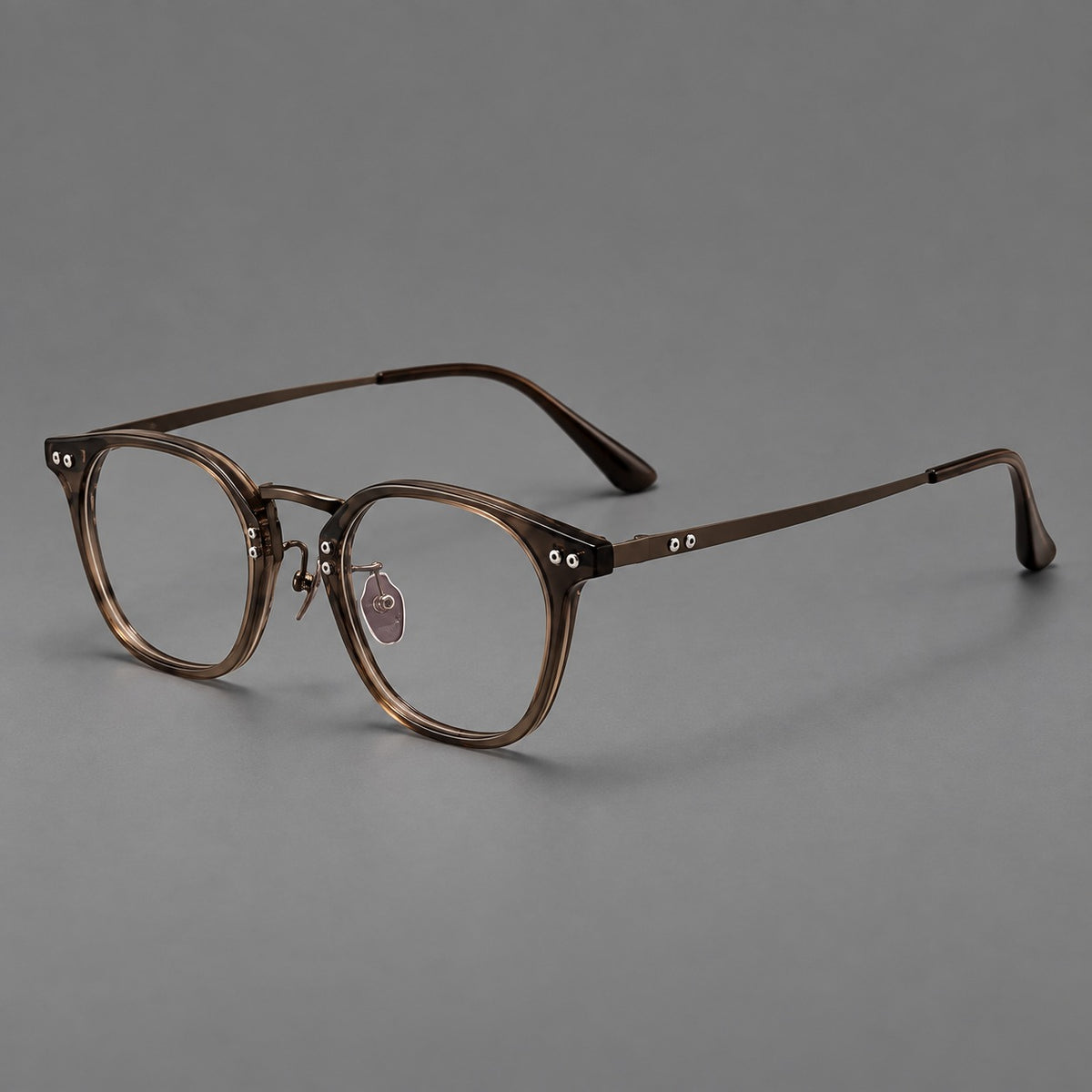 Retro acetate and titanium eyeglasses with softly rounded rims and a metal bridge in Coffee Brown, three quarter view