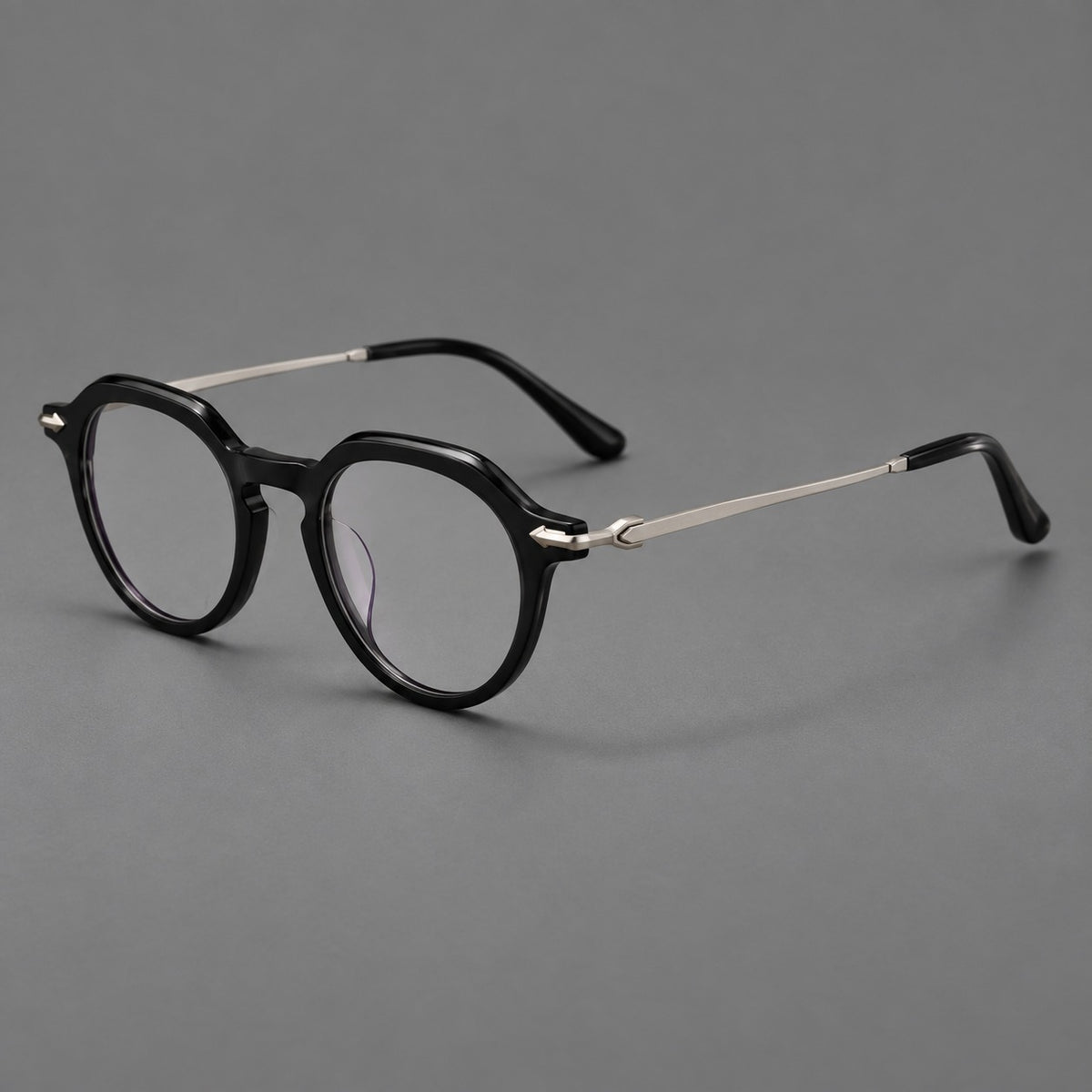 Retro acetate and titanium eyeglasses with panto rims and decorative arrow corner accents in Black / Silver, three quarter view