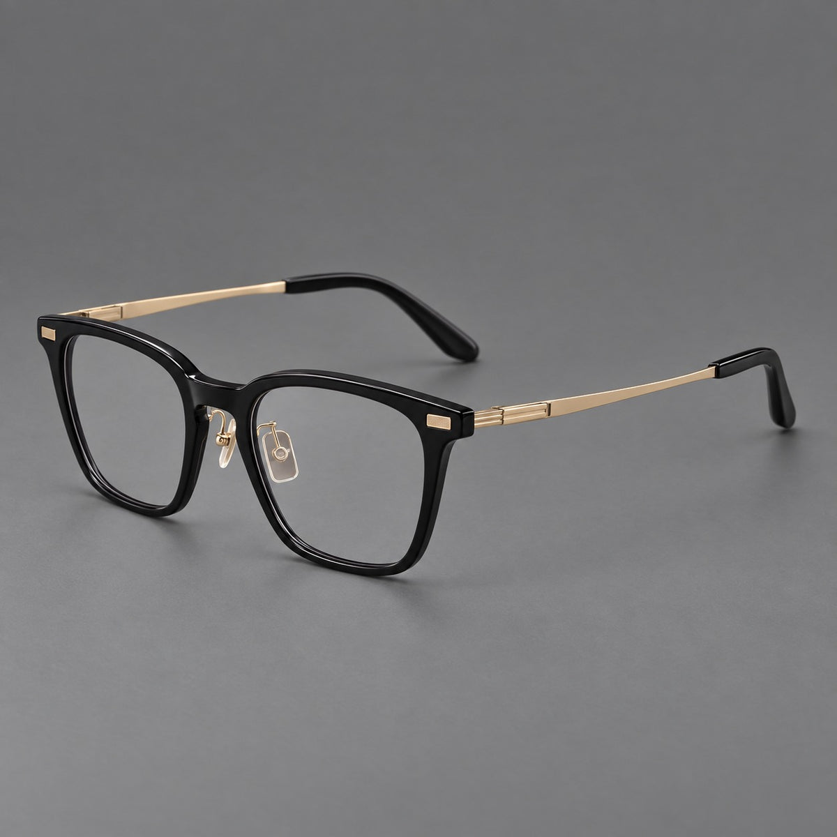 Classic acetate and titanium eyeglasses with rounded square rims and textured corner accents in Black / Gold, three quarter view
