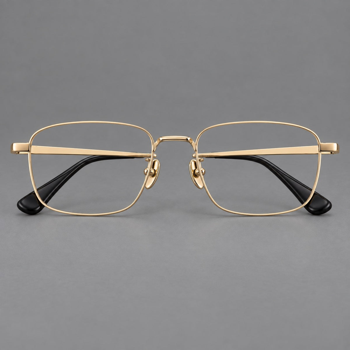 Modern square titanium glasses with an angular bridge and broad straight temples in Gold, front view
