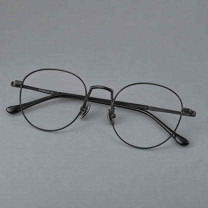 Retro round titanium glasses with a raised bridge and smooth corner shoulders in Black, three quarter view
