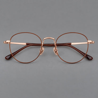 Retro round titanium glasses with a raised bridge and smooth corner shoulders in Brown and Rose Gold, front view frame detail