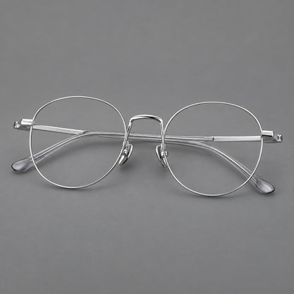 Retro round titanium glasses with a raised bridge and smooth corner shoulders in Silver, three quarter view additional product view