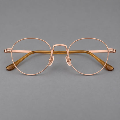 Retro round titanium glasses with a raised bridge and smooth corner shoulders in Rose Gold, front view additional product view