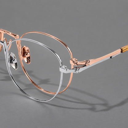 Retro round titanium glasses with a raised bridge and smooth corner shoulders, frame details additional product view