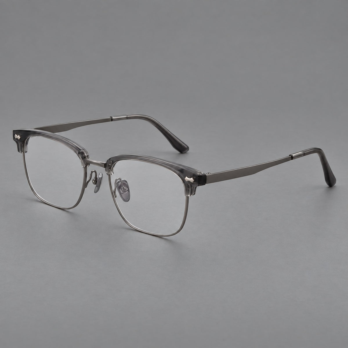 Classic browline titanium glasses with fine lower rims and subtle corner accents in Gunmetal, three quarter view