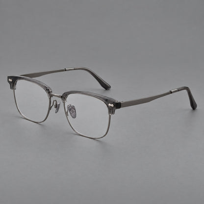Classic browline titanium glasses with fine lower rims and subtle corner accents in Gunmetal, three quarter view front view