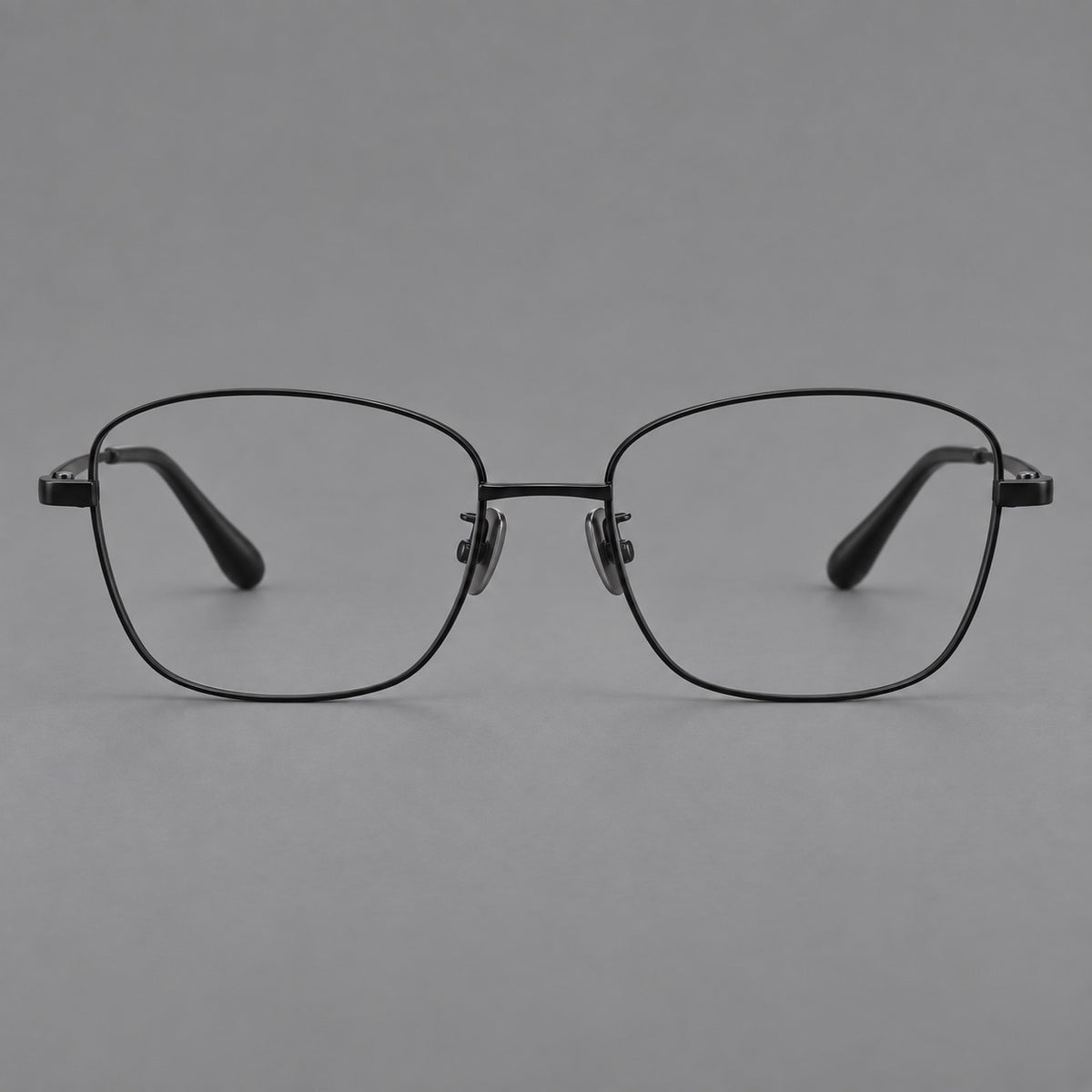 Soft square titanium glasses with angled upper corners and decorated hinges in Black, front view