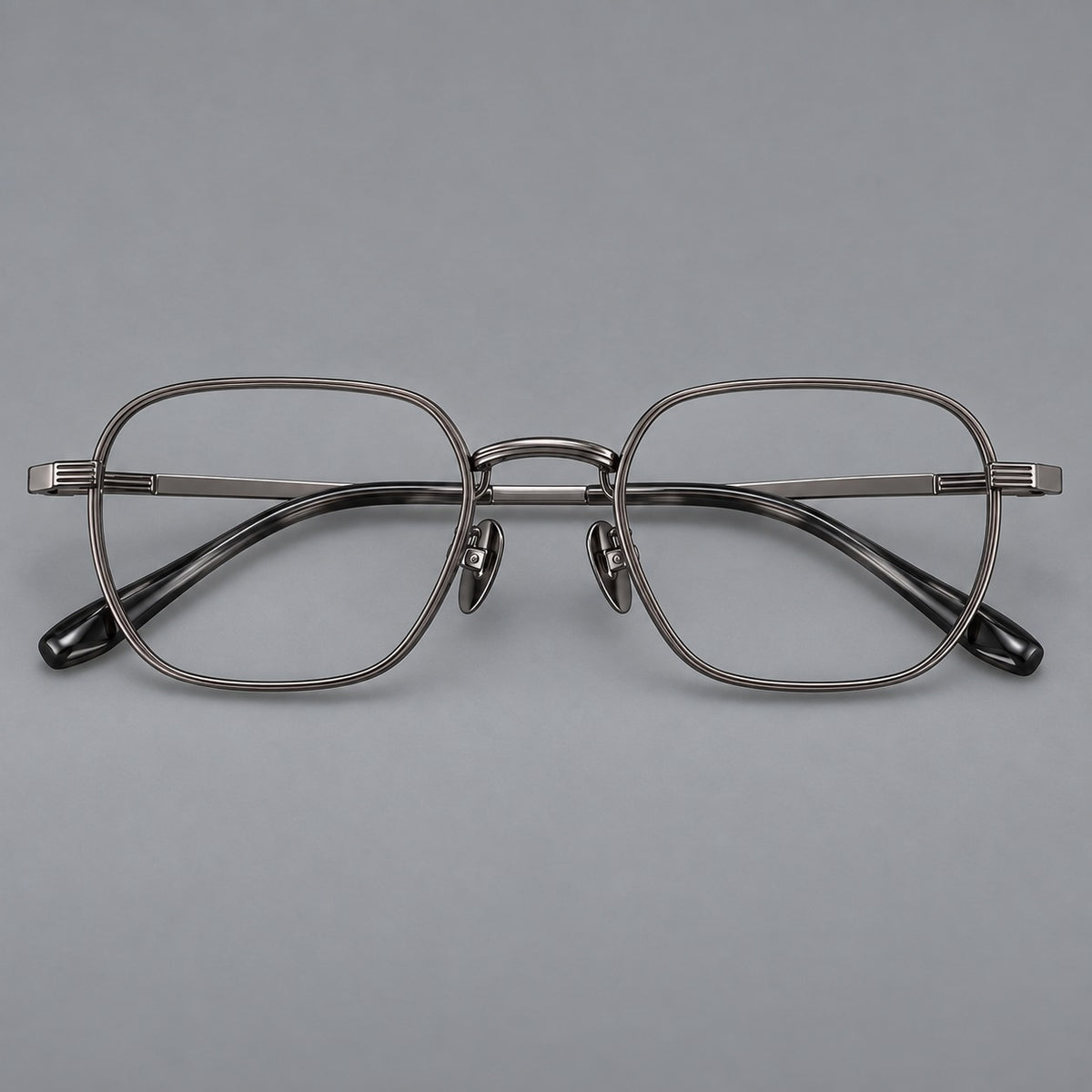 Retro square titanium glasses with rounded rims and finely grooved shoulders in Gunmetal, front view