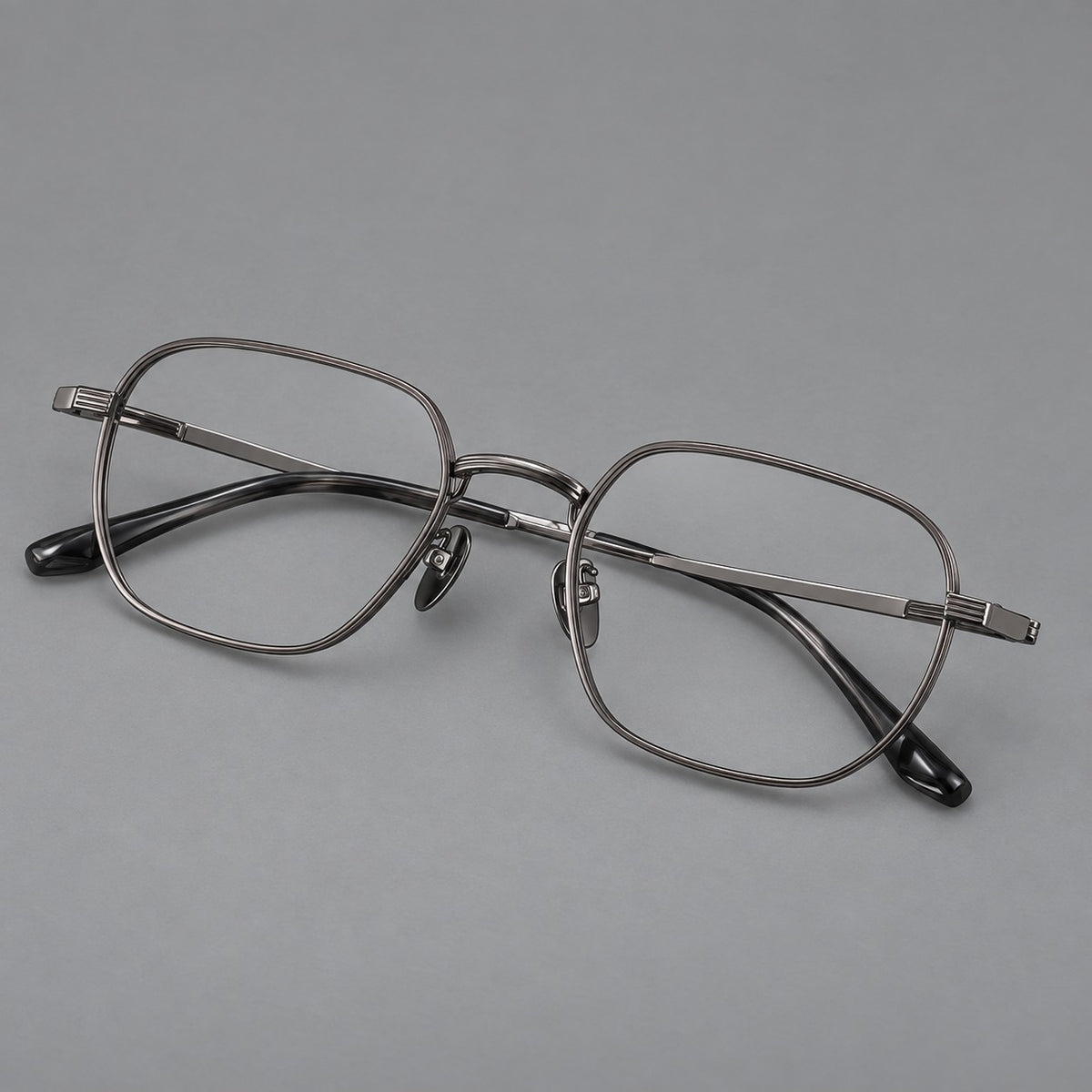 Retro square titanium glasses with rounded rims and finely grooved shoulders in Gunmetal, three quarter view