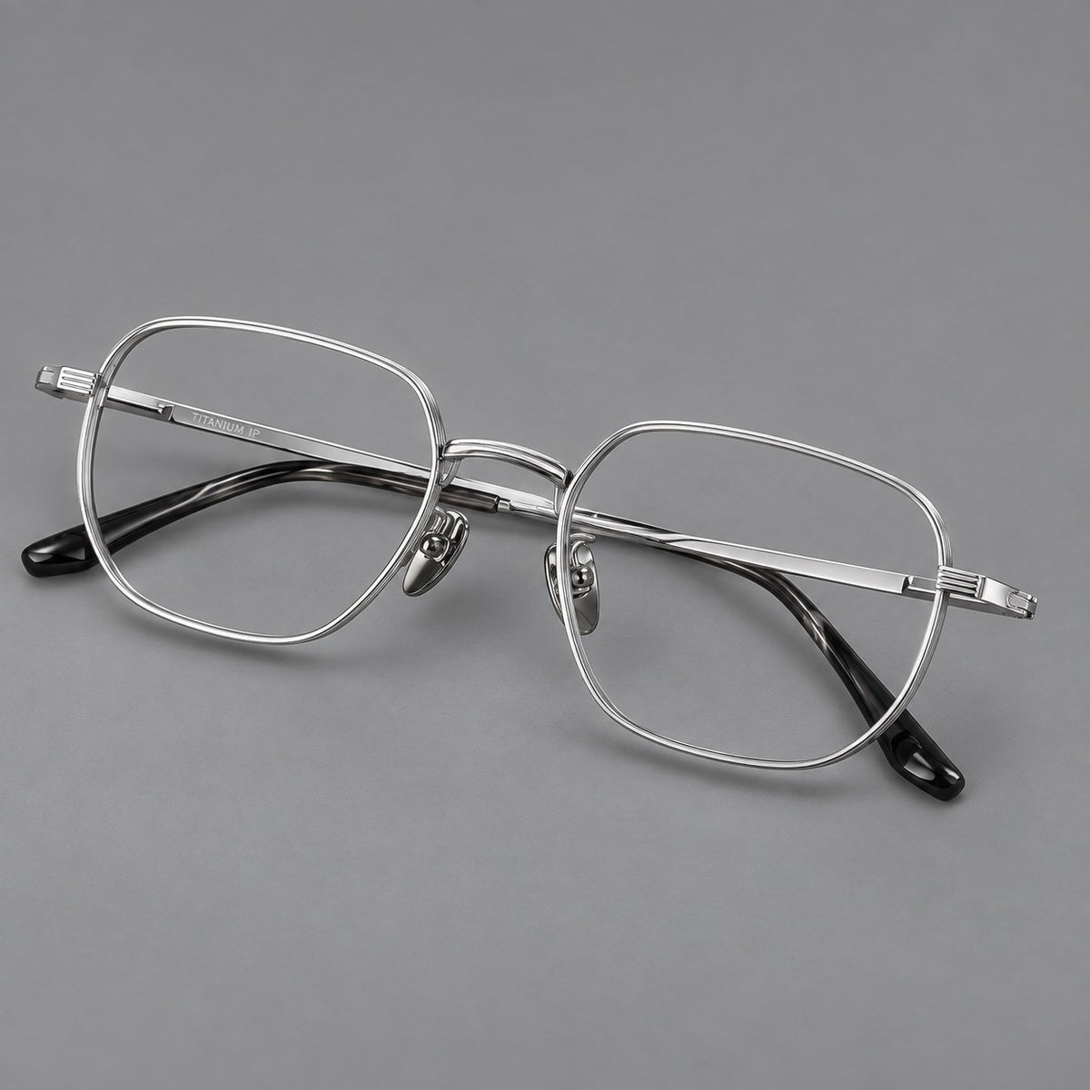 Retro square titanium glasses with rounded rims and finely grooved shoulders in Silver, three quarter view